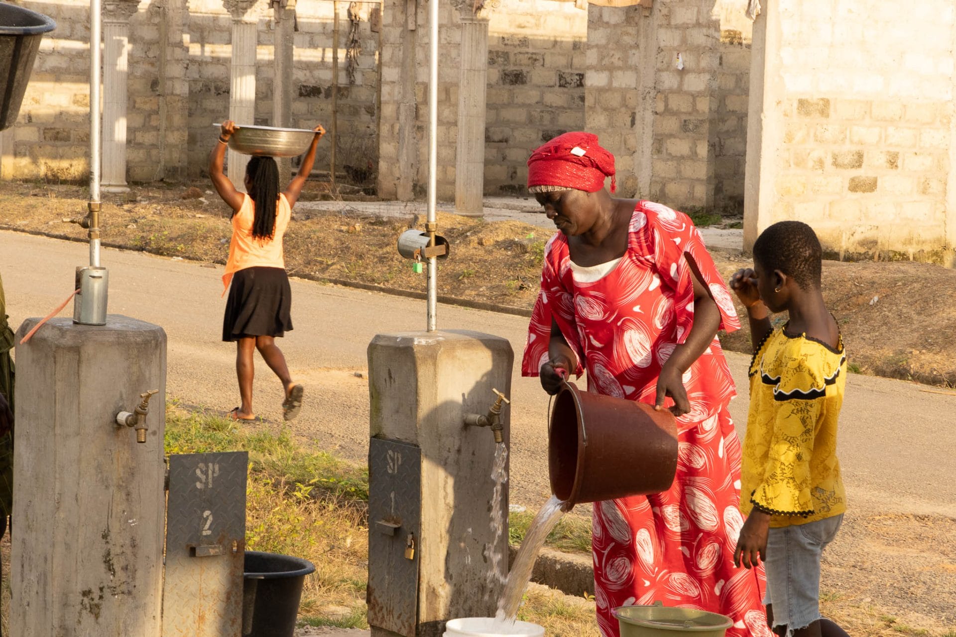 woman fetching water from a standpipe