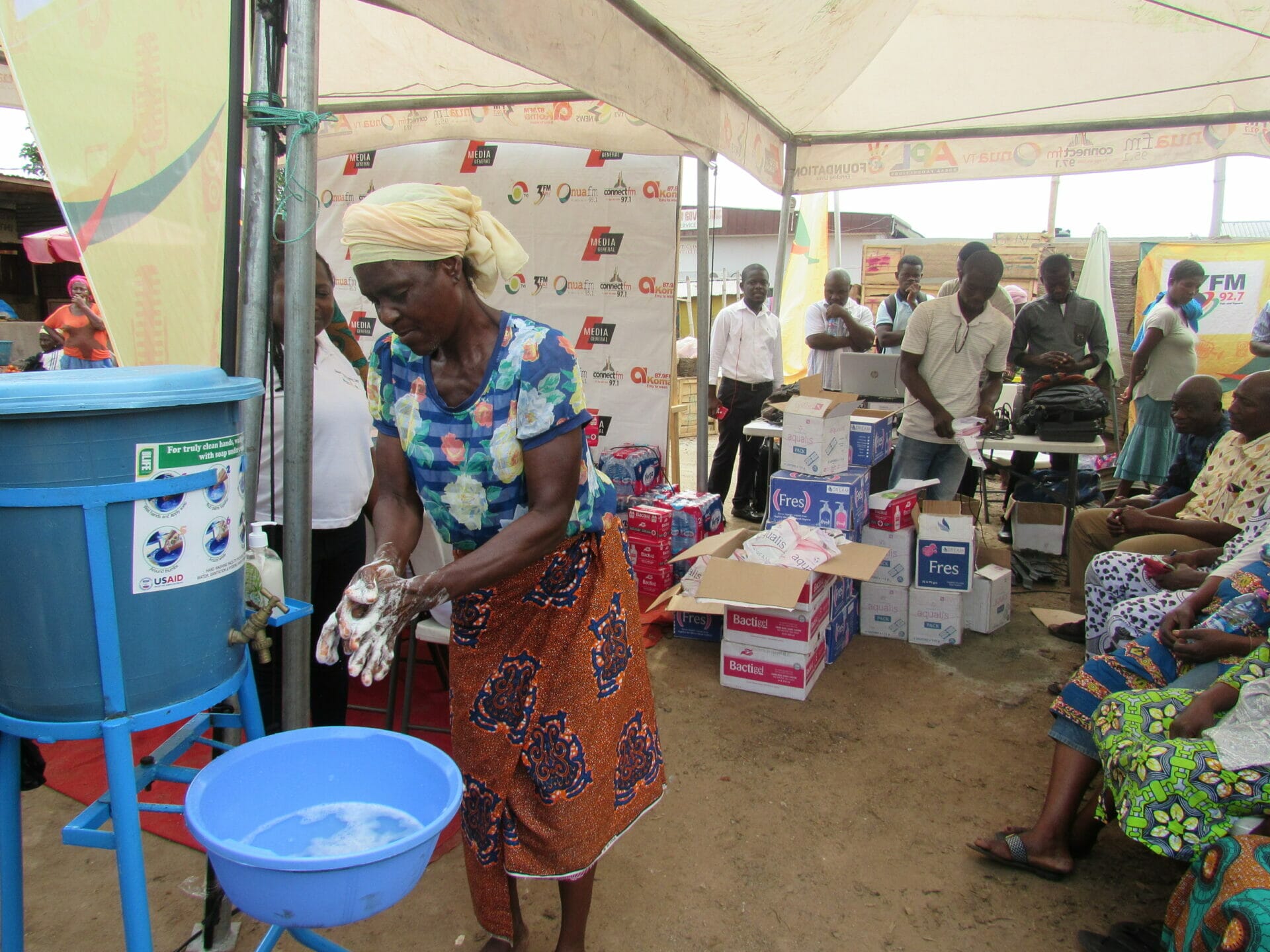 Market woman at Mallam Attah Market washing her hands on Global Handwashing Day 2019